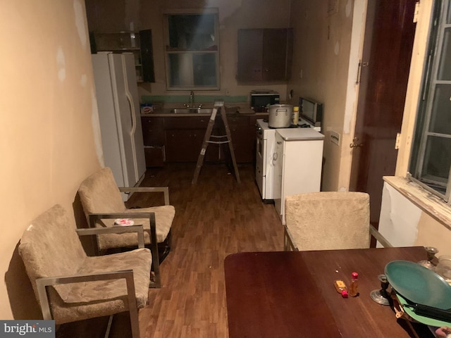 kitchen with sink, white fridge, dark hardwood / wood-style floors, and range