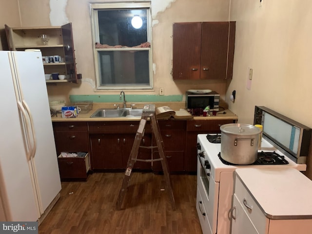 kitchen with dark hardwood / wood-style flooring, white appliances, sink, and dark brown cabinetry