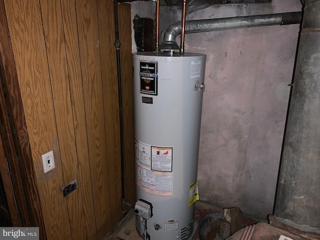 utility room featuring water heater