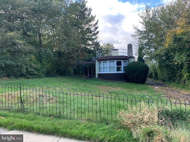 view of yard with a balcony