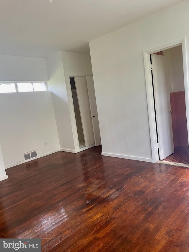 spare room featuring dark hardwood / wood-style floors