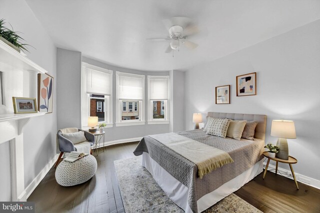 bedroom with dark hardwood / wood-style floors and ceiling fan