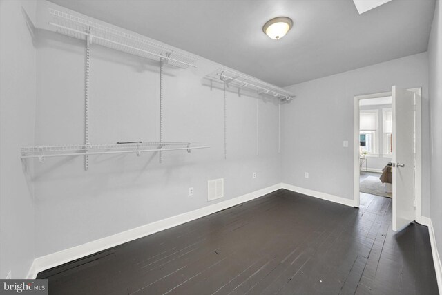 walk in closet featuring dark wood-type flooring