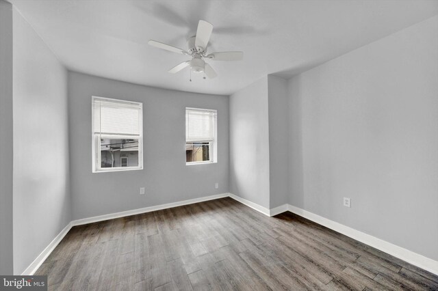 unfurnished room with ceiling fan and dark hardwood / wood-style floors