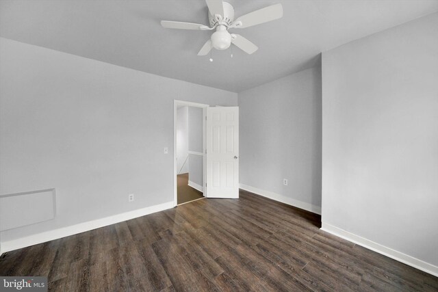 unfurnished room with ceiling fan and dark hardwood / wood-style flooring