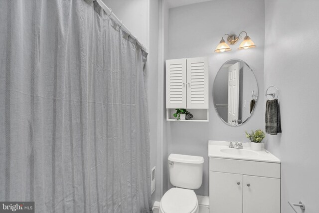 bathroom featuring oversized vanity and toilet