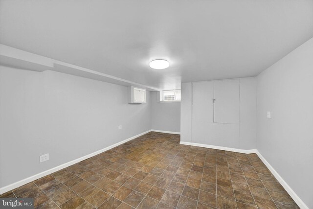 basement with dark tile floors