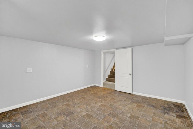 basement featuring dark tile flooring