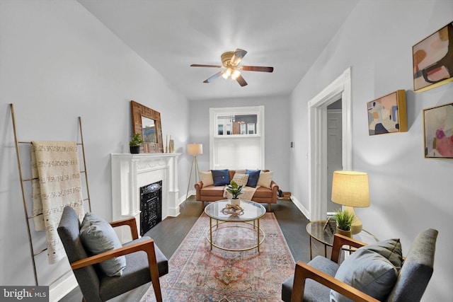 living room with ceiling fan, dark hardwood / wood-style flooring, and a high end fireplace