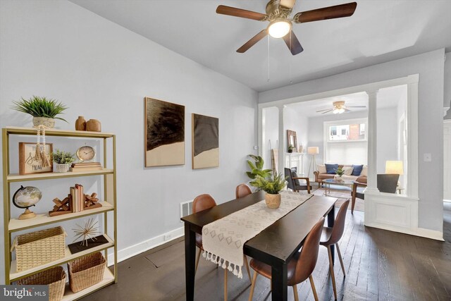 dining space with dark wood-type flooring and ceiling fan