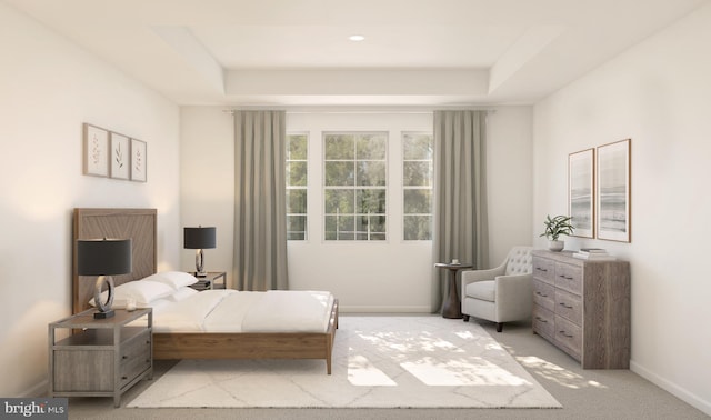 bedroom with baseboards, a raised ceiling, and light colored carpet