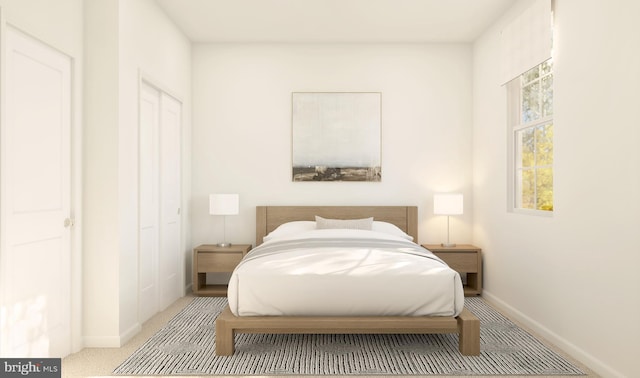 bedroom featuring light colored carpet and a closet