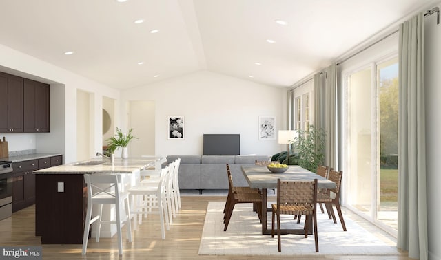 dining area featuring lofted ceiling, light wood-style flooring, and recessed lighting