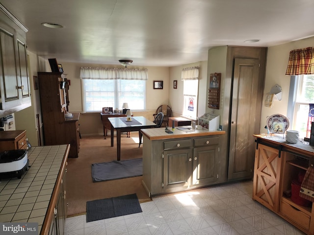 kitchen with tile countertops and light tile floors