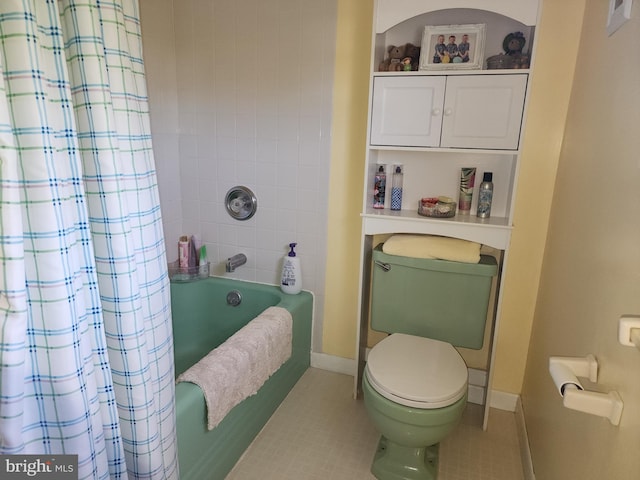 bathroom with shower / tub combo, toilet, and tile flooring