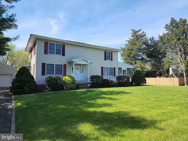 view of front of property with a garage and a front yard