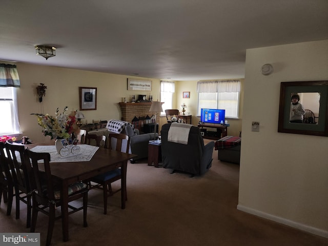 dining space featuring carpet and a fireplace