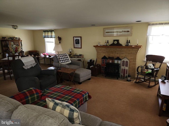 carpeted living room featuring a brick fireplace