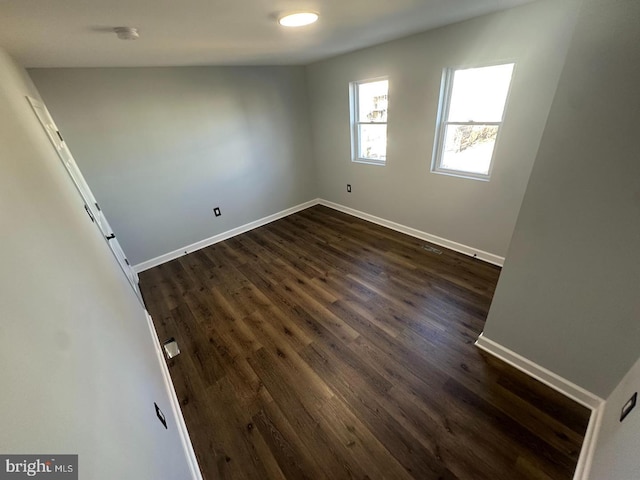 empty room with dark hardwood / wood-style floors