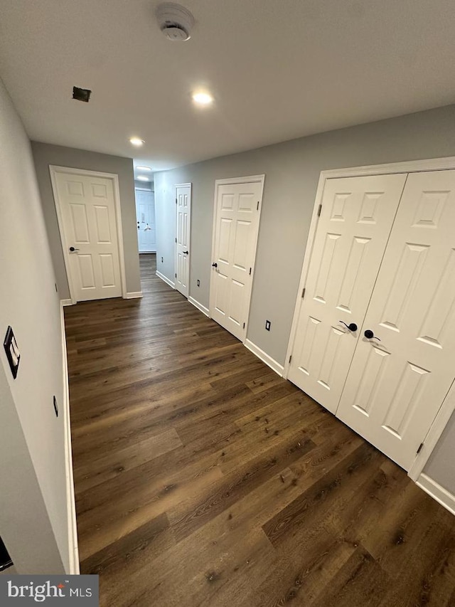 hall with dark hardwood / wood-style floors