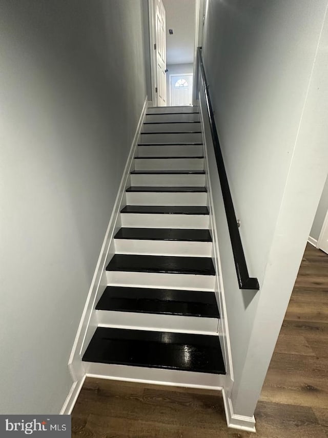 stairs with wood-type flooring