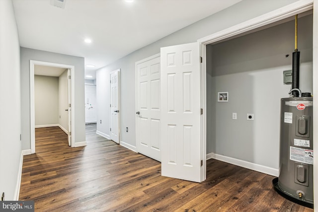 hall featuring electric water heater and dark wood-type flooring