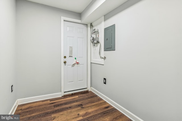 doorway to outside with dark hardwood / wood-style floors and electric panel