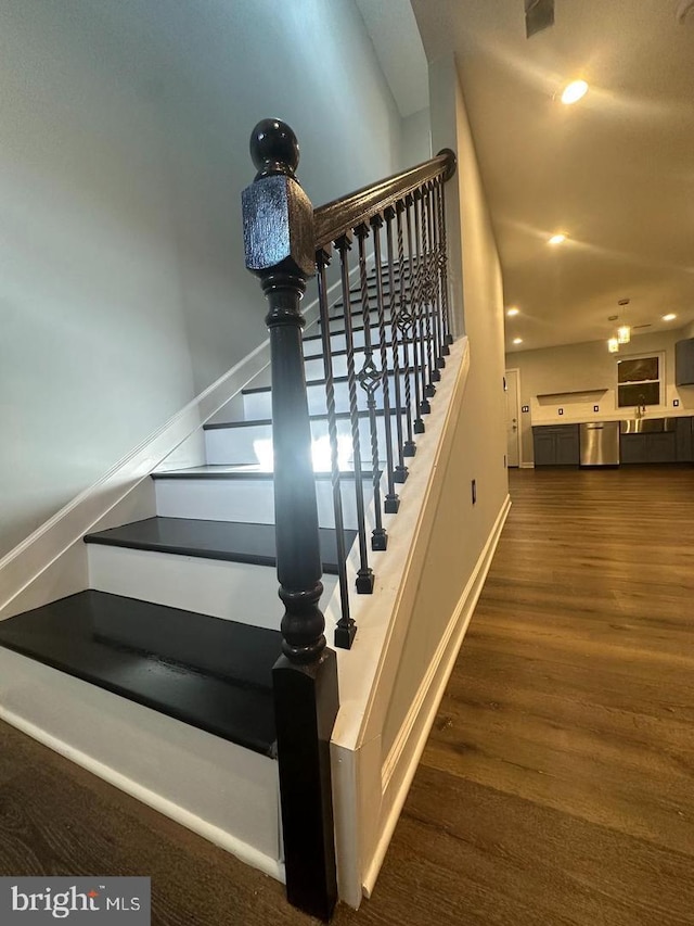 stairway featuring hardwood / wood-style floors