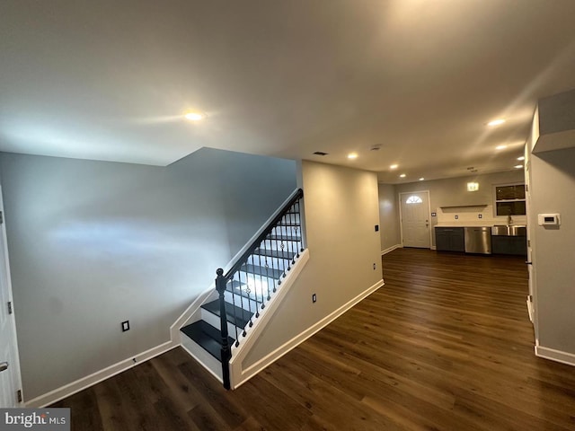 stairway featuring wood-type flooring