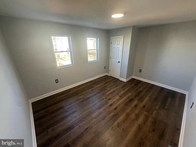 spare room featuring dark hardwood / wood-style floors