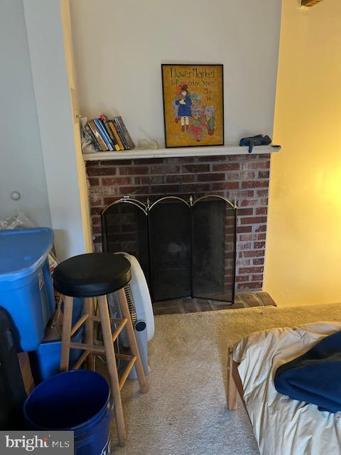 carpeted living room featuring a brick fireplace