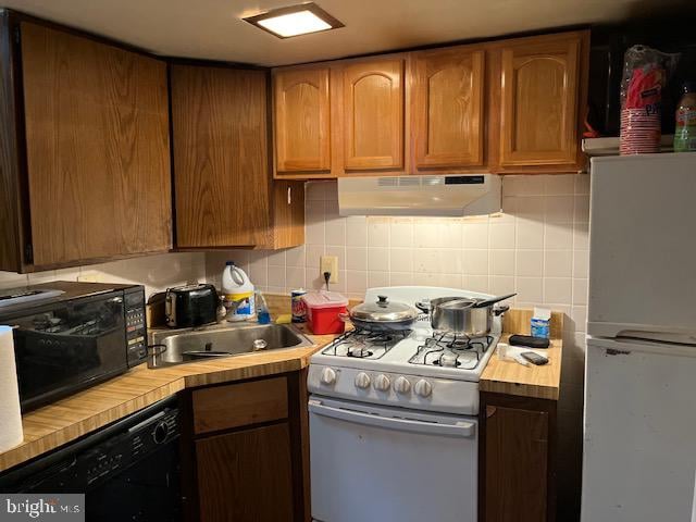 kitchen featuring backsplash and black appliances