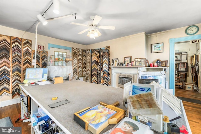 home office with hardwood / wood-style flooring, ceiling fan, rail lighting, and a fireplace