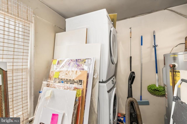 interior details with electric water heater and stacked washer / drying machine