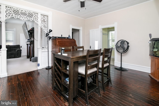 carpeted dining room with ceiling fan and crown molding