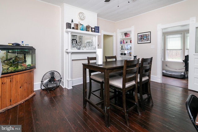 dining space featuring ceiling fan, dark wood-type flooring, built in shelves, and ornamental molding