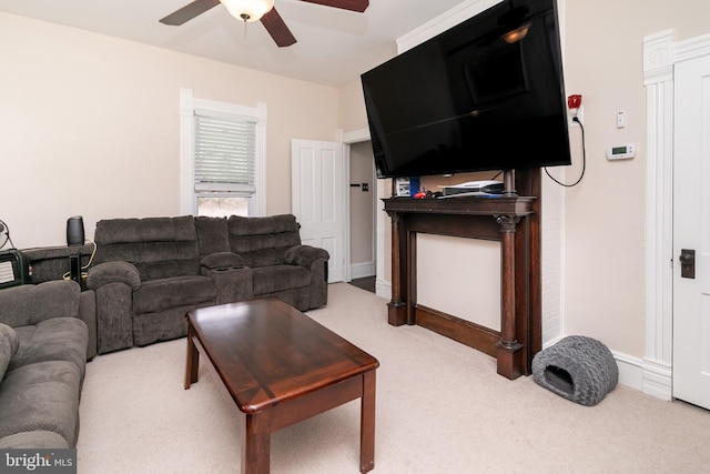 carpeted living room with ceiling fan