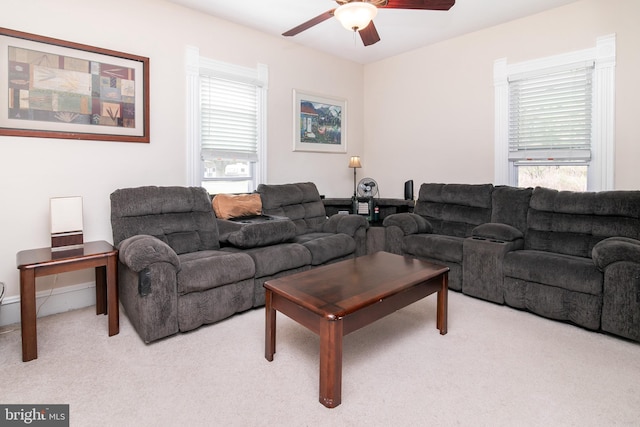 carpeted living room featuring ceiling fan