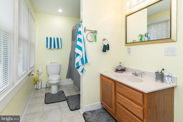 bathroom featuring toilet, oversized vanity, and tile flooring