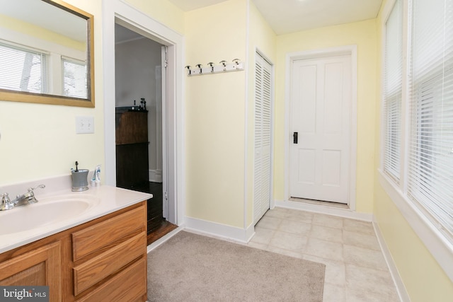 bathroom with tile flooring and vanity