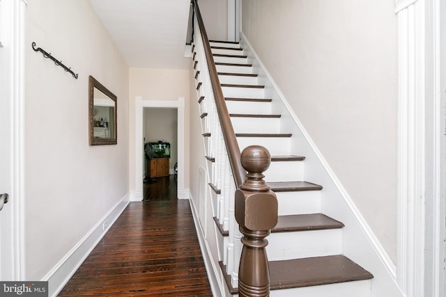 stairway featuring dark wood-type flooring