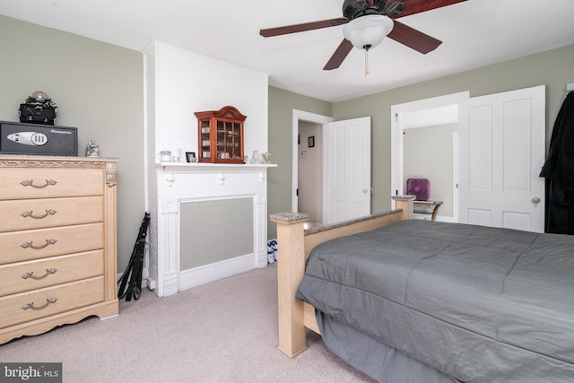 bedroom featuring light carpet and ceiling fan