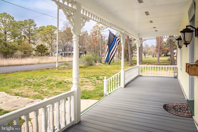 wooden terrace with a yard