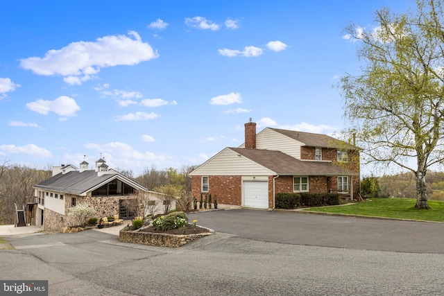 view of front facade with a front lawn and a garage