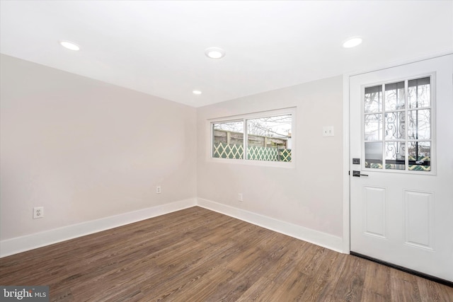 foyer entrance with a healthy amount of sunlight and dark hardwood / wood-style flooring