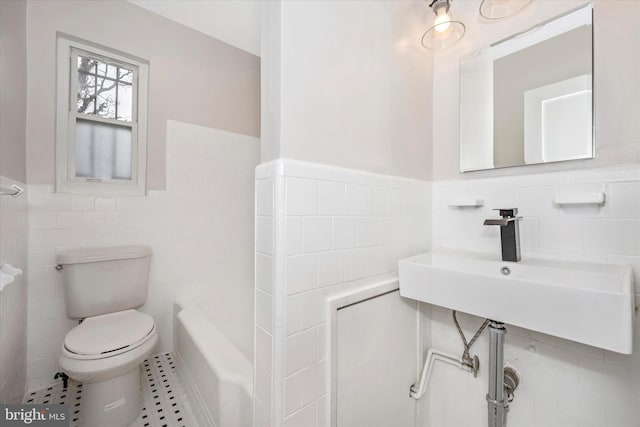 bathroom with tile flooring, tile walls, sink, tasteful backsplash, and toilet