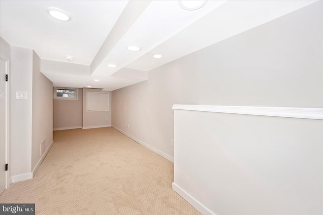 basement featuring light carpet