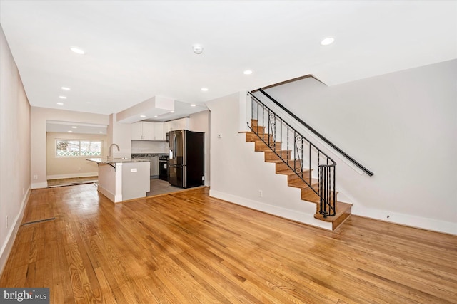 unfurnished living room with light hardwood / wood-style flooring