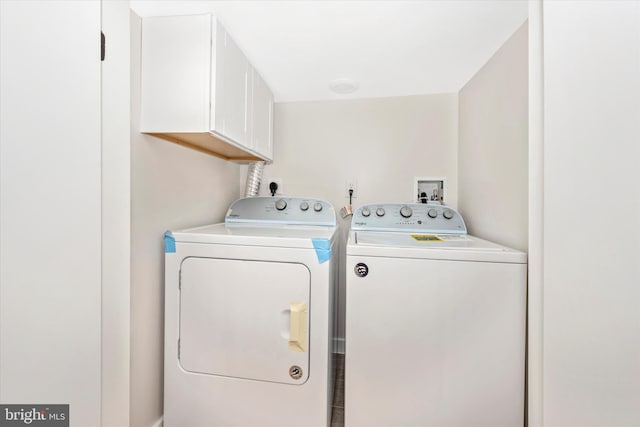 laundry room featuring cabinets, washer and clothes dryer, and washer hookup