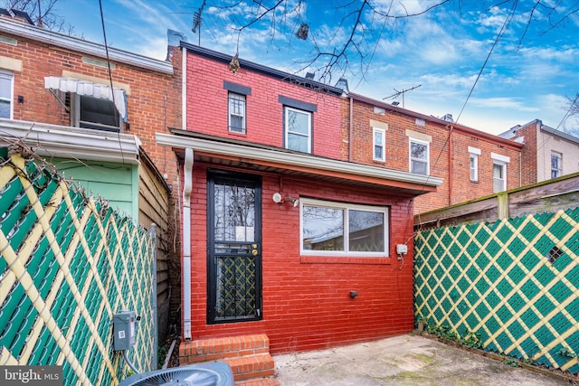 rear view of property featuring central AC